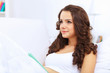 Young woman at home with a book