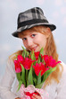 beautiful girl in hat with tulips