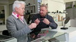 Optician helping senior customer finding glasses