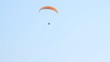 Paragliding over the mountains against clear blue sky