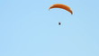 Paragliding over the mountains against clear blue sky