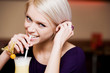Playful woman drinking a cocktail