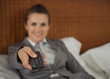 Closeup on tv remote control in hand of business woman 