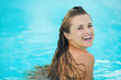 Portrait of happy young woman in pool