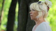 single adult woman sitting on a park bench