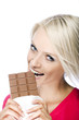 Woman eating a tempting bar of chocolate