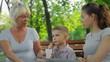 mother and daughter talking with them, baby sitting