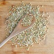 Raw green buckwheat with a tblespoon
