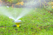 sprinkler watering the lawn in an urban garden