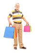 Full length portrait of a mature gentleman with shopping bags