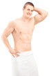 Handsome young man in towel posing after shower