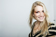 Foto: Smiling blond woman in a stylish top Smiling blond woman in a stylish top