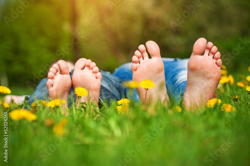 Photo: feet on grass. Family picnic in spring park feet on grass. Family picnic in spring park