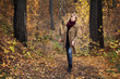 Young blond woman in autumn forest
