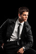 A fashionable young man with a jacket and tie posing