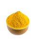 Turmeric powder in a ceramic container over white background