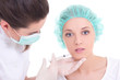 Photo: female doctor giving an injection on the young woman's face female doctor giving an injection on the young woman's face