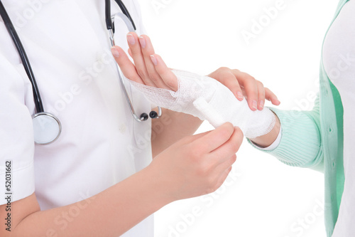 Photo: doctor bandaging female hand over white background doctor bandaging female hand over white background