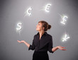 young lady standing and juggling with currency icons