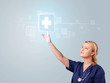 Young nurse pressing modern medical type of buttons
