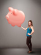 Young girl holding a huge savings piggy bank