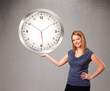 Photo: Attractive lady holding a huge clock Attractive lady holding a huge clock