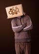 Young man gesturing with a cardboard box on his head with spur w