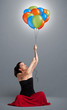 Young woman holding colorful balloons
