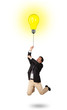 Photo: Happy man holding a light bulb balloon Happy man holding a light bulb balloon