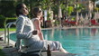 Happy businesswomen relaxing by the swimming pool