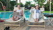 Businesswomen with laptop and tablet relaxing on sunbeds