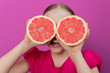 Grapefruit - a young girl with grapefruits - diet concept