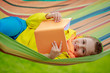 Young girl in headphones reading a book