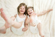 Photo: happy little girls lying on back top view happy little girls lying on back top view