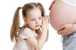 Kid girl listening with can pregnant mother's stomach