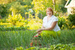 Happy  woman in vegetables garden