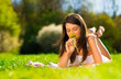 Smiling young woman holding some flowers happily