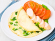 Breakfast. scrambled eggs, sausage and tomatoes