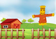 A scarecrow inside the wooden fence