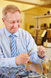 Photo: Optician repairing glasses Optician repairing glasses