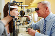 Photo: Ophthalmologist examing woman with slit lamp Ophthalmologist examing woman with slit lamp