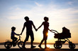 happy family walking on sunset
