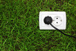 electric power receptacle on a green grass background