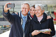 Photo: Family taking self portrait with smartphone Family taking self portrait with smartphone