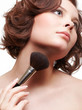 Foto: woman with makeup brush woman with makeup brush
