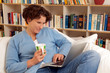 Junge Frau mit Kaffee und Laptop