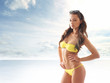 Photo: Stock photo of young, fit and sexy woman in yellow swimsuit Stock photo of young, fit and sexy woman in yellow swimsuit