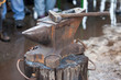 Old anvil with blacksmith tools on the outdoors