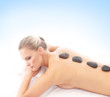 Young attractive woman getting hot stone treatment