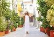 Young and beautiful lady walking down the ancient street